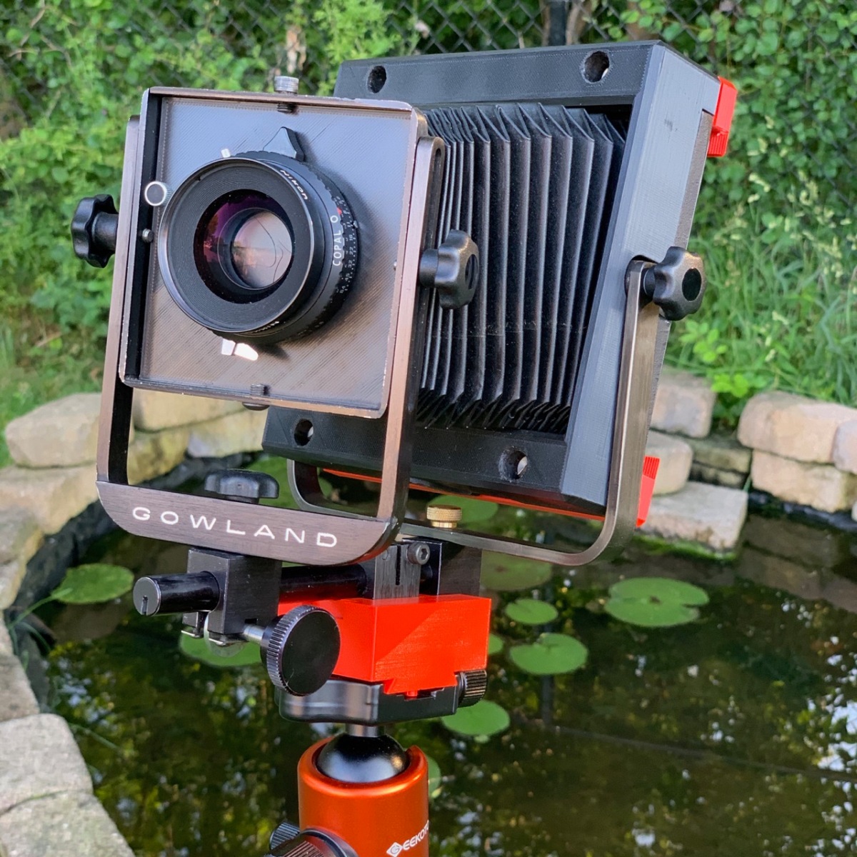 Gowland Pocket View Camera with modifications shown on tripod in front of pond.